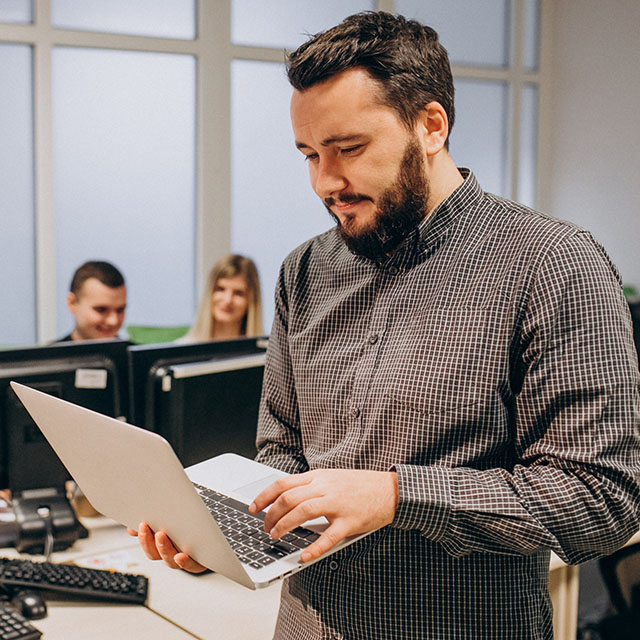 Workers at an IT company working on a computer